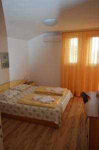 a bedroom with a bed with two towels on it at Yanis in Chernomorets