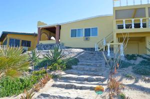 a house with stairs in front of a building at Casa Pelicano in Puerto Peñasco