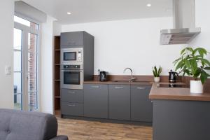 a kitchen with stainless steel appliances and a counter at Résidence Solférino in Laval