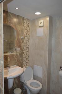 a bathroom with a toilet and a sink at Yanis in Chernomorets +45 photos