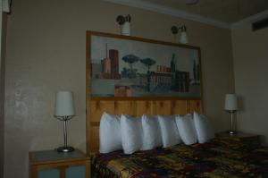 a hotel room with a bed with white pillows at Sea Vista Motel in New Smyrna Beach