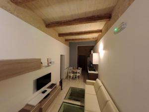 a living room with a couch and a dining room at Great Siege Apartment in Senglea