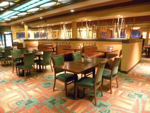a dining room with tables, chairs, and tables at Ute Mountain Casino Hotel in Towaoc