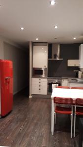 a kitchen with a red refrigerator and a table at Apartamento Manuela Sancho in Zaragoza