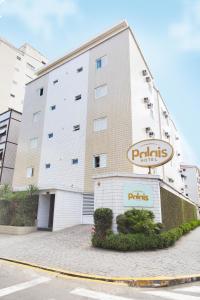 a building with a sign in front of it at Palais Hotel in São Vicente