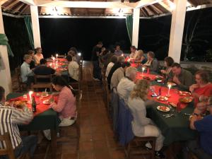 a group of people sitting at tables in a restaurant at Jungle Lodge El Jardin Aleman in Tena