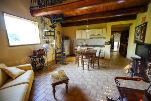 a living room and kitchen with a couch and a table at Holiday Home Soratte in Civitella San Paolo