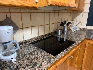 a kitchen counter with a sink and a coffee maker at Casa Coromines in Alcudia