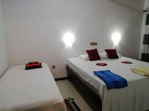 Postel nebo postele na pokoji v ubytování Lak Nilla Guest House