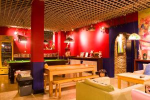 a restaurant with a table and a pool table at 大连天天国际青年旅社 in Dalian