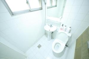 a white bathroom with a toilet and a sink at Stitches House in Seoul +63 photos