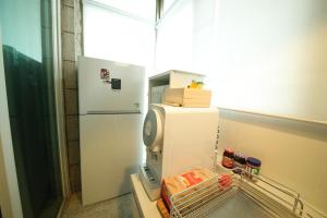 a refrigerator in a kitchen with a window at Stitches House in Seoul