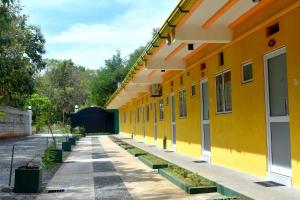 an empty yellow building with a row of windows at Sri Mayura Holiday Resort in Kataragama