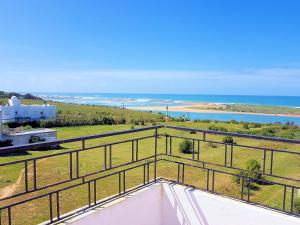 a view of the ocean from the balcony of a house at Maison de la Lagune in Oualidia