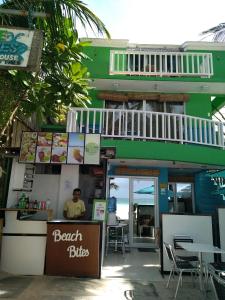 a beach bites restaurant with a man sitting at the counter at Bluewaves Beach House in Boracay
