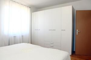 1 dormitorio con armarios blancos y 1 cama en Peaceful Apartment Ankaran SP, en Ankaran