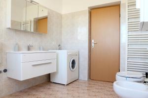 a bathroom with a washing machine and a sink at Peaceful Apartment Ankaran SP in Ankaran +9 photos