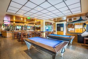 a pool table in a room with a bar at Narrabeen Sands Hotel by Nightcap Plus in Narrabeen
