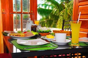 a breakfast table with food and drinks on a table at Senero House in Bentota