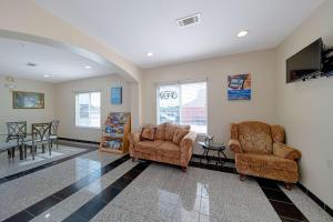 a living room with two chairs and a table at Motel 6-Rhome, TX in Rhome