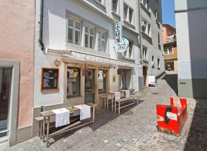 a street with tables and chairs outside of a building at Hotel Rössli in Zurich