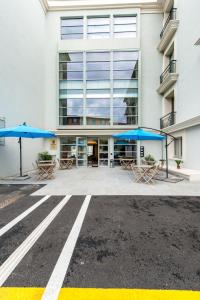 a building with blue umbrellas in front of it at Best Western Hôtel Journel Antibes Juan-les-Pins in Antibes