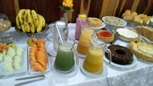 a table filled with different types of food and drinks at Kontiki Hotel in São Francisco do Sul