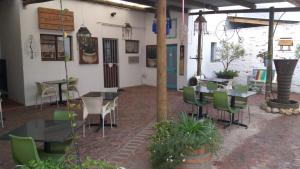 a patio with tables and chairs in a restaurant at Worcester Gallery Cottage in Worcester