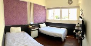 מיטה או מיטות בחדר ב-Penghu An-I Hotel