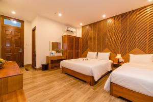 Postel nebo postele na pokoji v ubytování Phong Phu Villa Hoi An