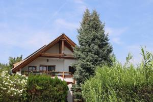 a house with a tree in front of it at Mandel Apartment in Paloznak