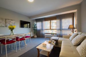 a living room with a couch and a table at Apartamento El Pedregal Playa de Ris in Noja