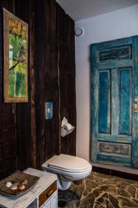 a bathroom with a toilet and an open door at Art Pension in Przecznica