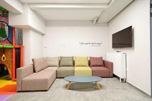 a living room with a couch and a table at Hercules Residence in Athens