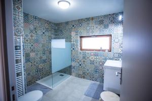 a bathroom with a shower and a toilet and a window at Cap Canche in Étaples