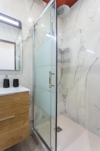 a shower with a glass door in a bathroom at CMG Nation/ Vincennes II in Paris