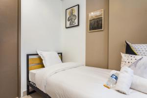 a bedroom with a bed with white sheets and pillows at CMG Nation/ Vincennes II in Paris