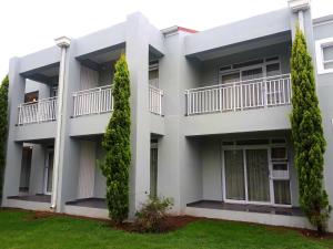 an image of a white apartment building at Queens Casino and Hotel in Queenstown