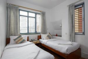 Letto o letti in una camera di Pacific Guest House