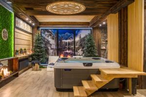 a jacuzzi tub in the middle of a room at Villa Adamo&SPA in Zakopane