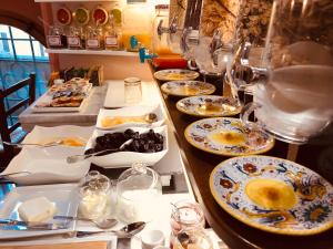 a buffet with plates of food on a table at Hotel Trattoria Pallotta in Assisi