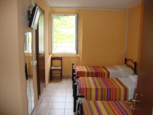 Postel nebo postele na pokoji v ubytování Albergo Gino
