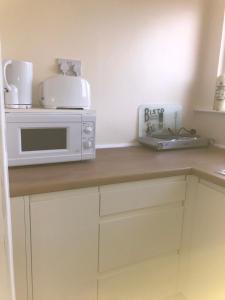 a kitchen counter with a microwave and a toaster at 24 Elmhurst Road in Lytham St Annes