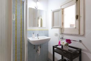 a bathroom with a sink and a mirror at Ai Tintori in Palermo +146 photos