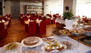 a room filled with lots of different types of cakes and pastries at Vicenza Tiepolo Hotel in Vicenza