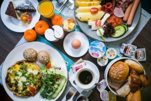 a table topped with plates of breakfast foods and drinks at Stay inn Hotel Gdańsk in Gdańsk