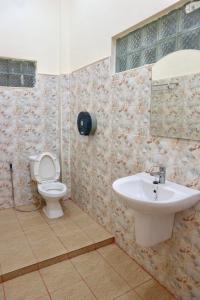 a bathroom with a toilet and a sink at IRIS MOTEL in Tachilek