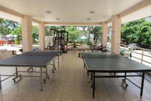 a row of ping pong tables in a room at B&B View Talay 1B by Franco Jontiem in Pattaya South