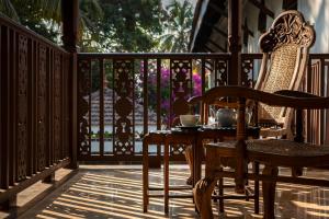 a patio with a table and chairs on a porch at The Postcard Cuelim, Goa in Utorda