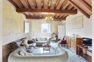 a living room with two couches and a table at La Canonica di Alica in Palaia